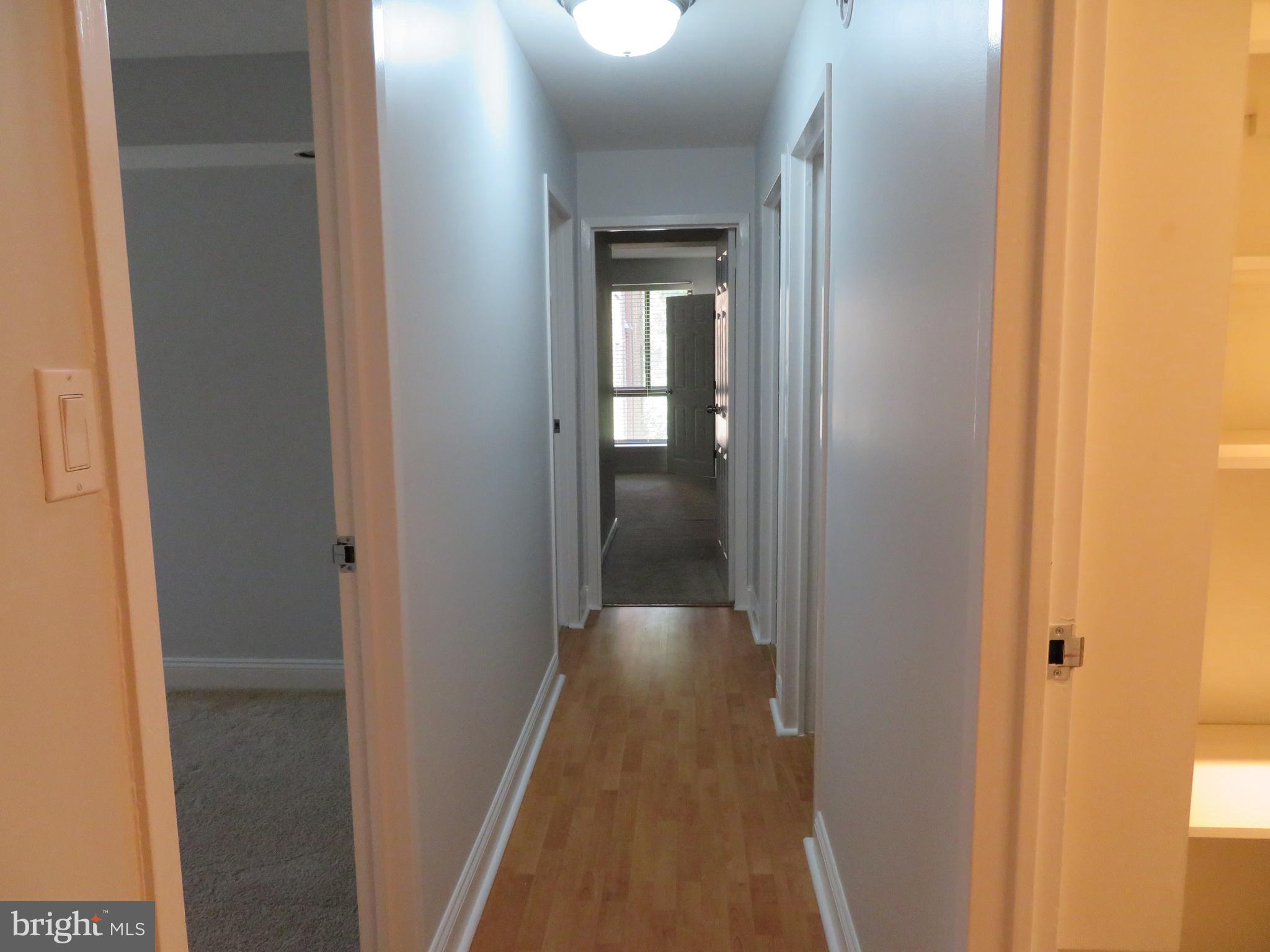 11236 Chestnut Grove Square, Unit 261 Reston, VA 20190 - Photo 17 of 30 a view of a hallway with wooden floor