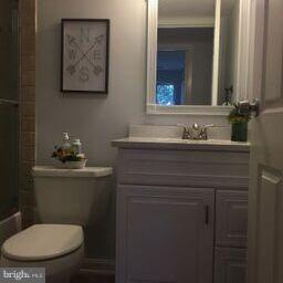 11236 Chestnut Grove Square, Unit 261 Reston, VA 20190 - Photo 22 of 30 a bathroom with a toilet sink and mirror