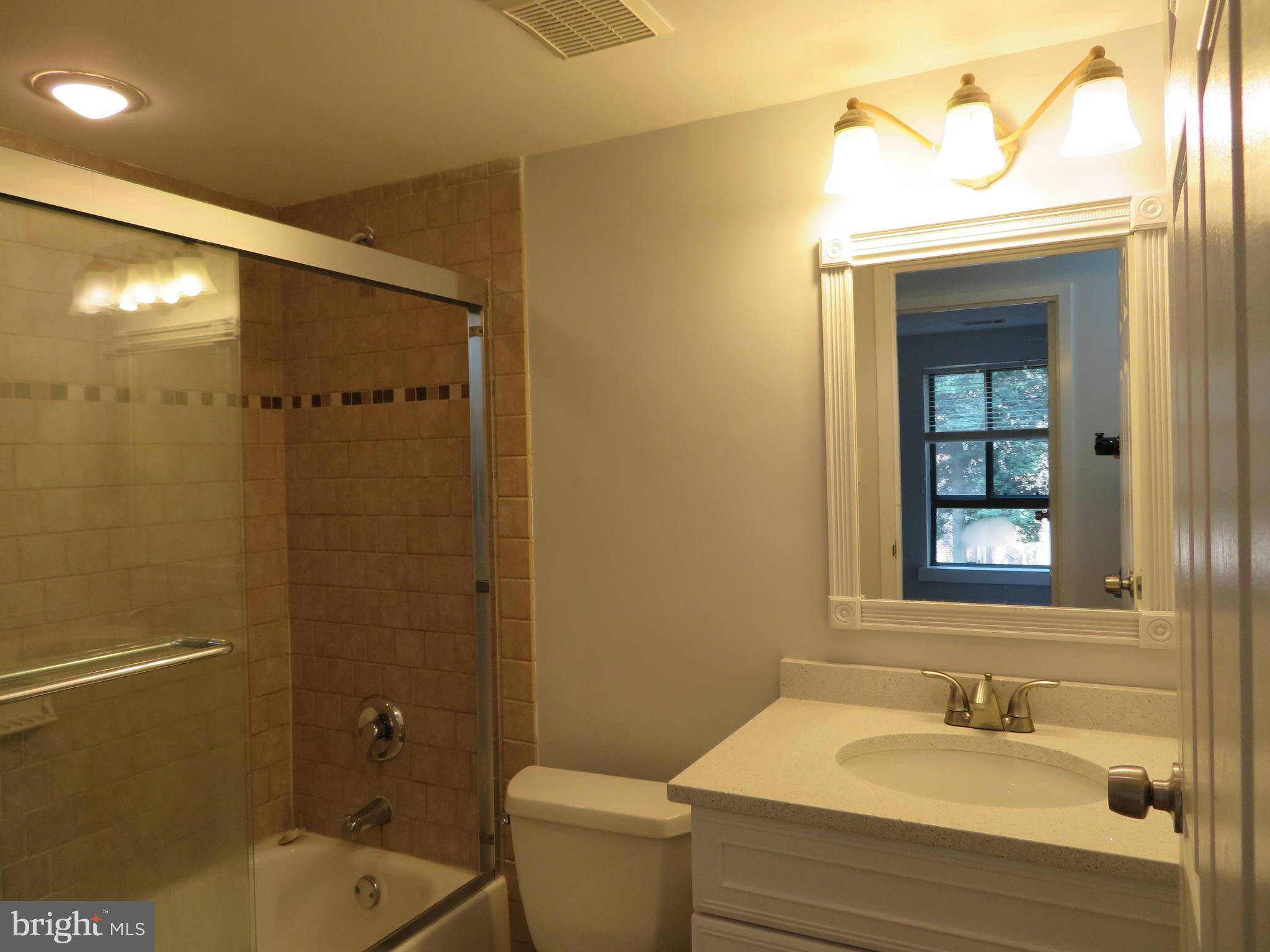 11236 Chestnut Grove Square, Unit 261 Reston, VA 20190 - Photo 27 of 30 a bathroom with a sink toilet and shower