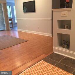 11236 Chestnut Grove Square, Unit 261 Reston, VA 20190 - Photo 8 of 30 a view of an empty room with wooden floor and a fireplace