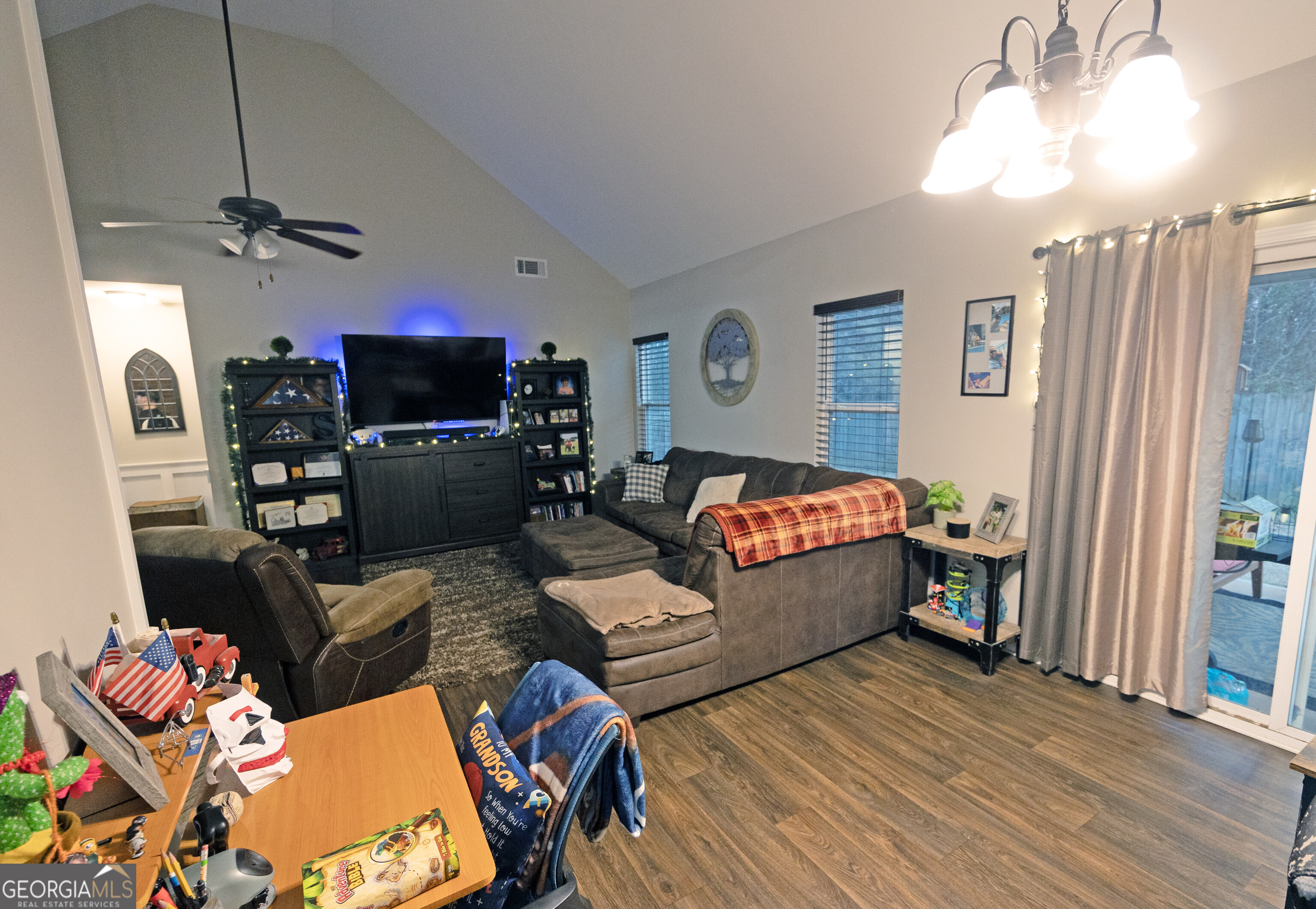 104 Savannah Way Milner, GA 30257 - Photo 17 of 27 a living room with furniture a flat screen tv and a window