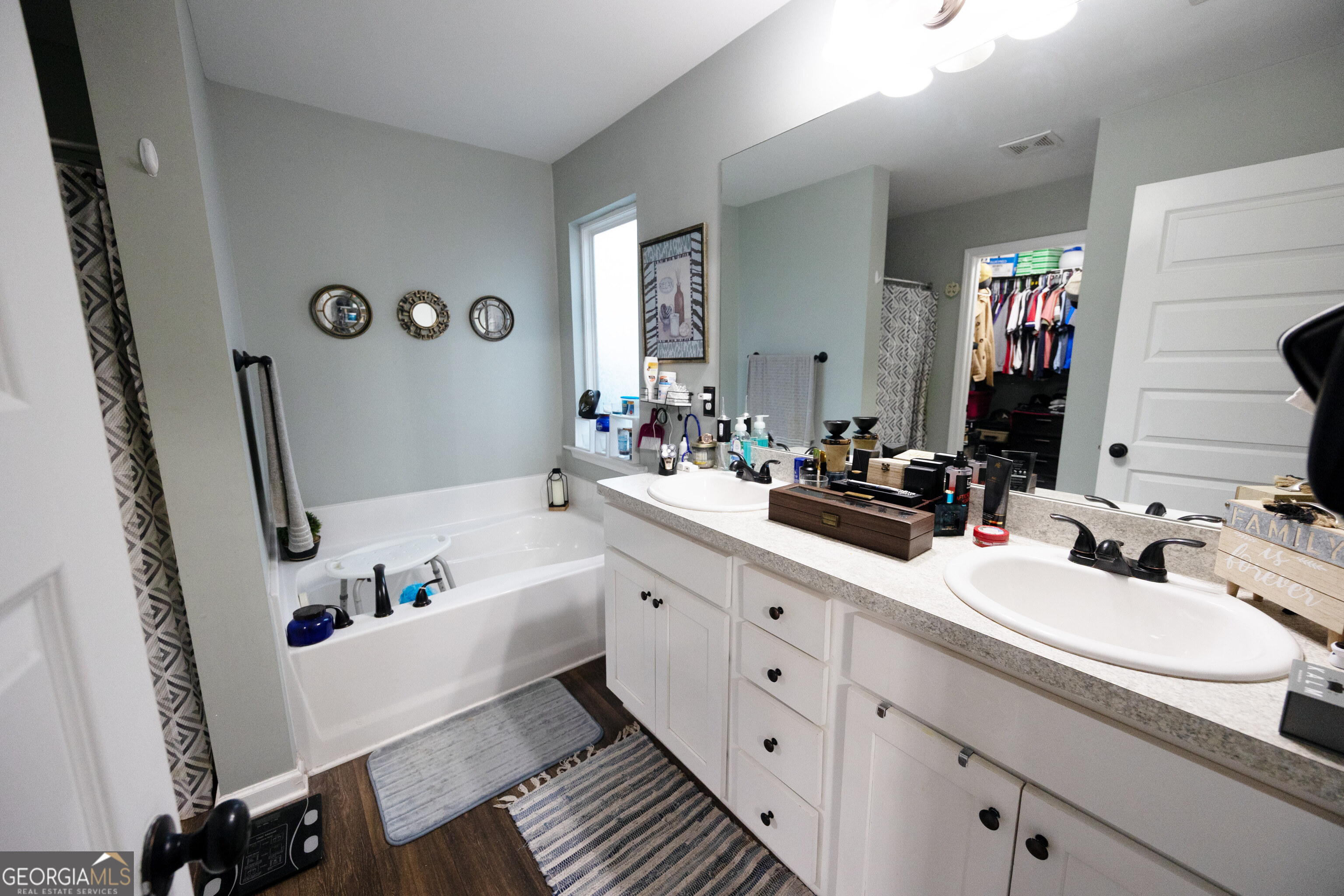104 Savannah Way Milner, GA 30257 - Photo 23 of 27 a bathroom with a tub sink and mirror