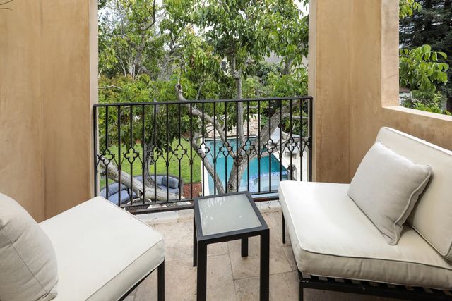a dining room with furniture and a potted plant