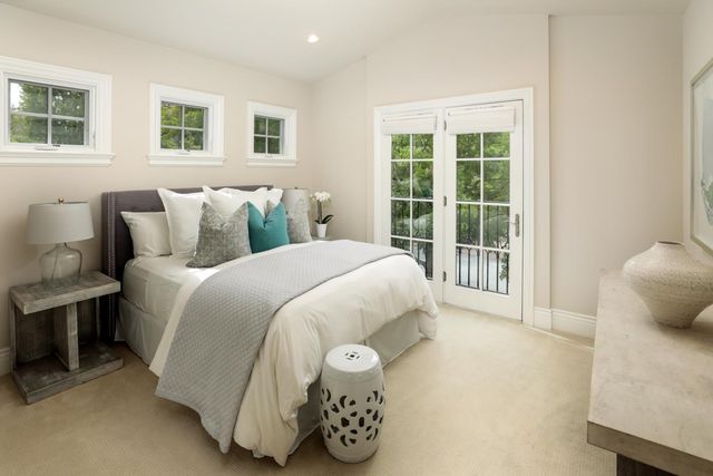 a spacious bedroom with a bed and a window