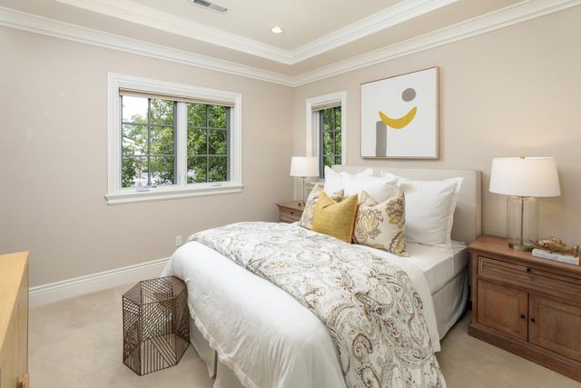 a bedroom with a bed and painting on the wall