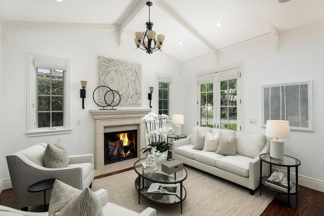 a living room with furniture fireplace and window