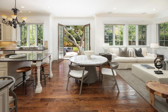 a living room with fireplace furniture and a large window