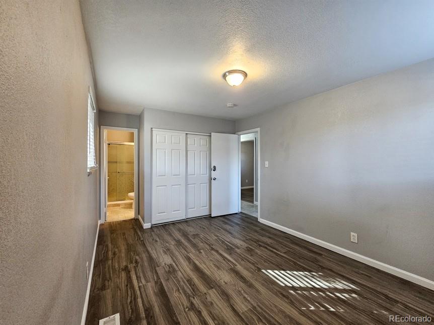 5542 Scranton Street Denver, CO 80239 - Photo 20 of 36 a view of an empty room and wooden floor