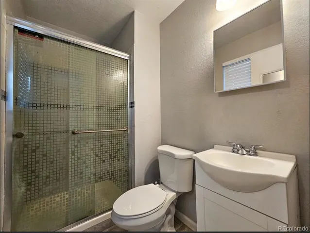 a bathroom with a toilet sink and shower