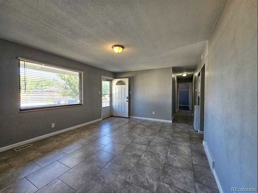 5542 Scranton Street Denver, CO 80239 - Photo 23 of 36 a view of an empty room with window and bathroom