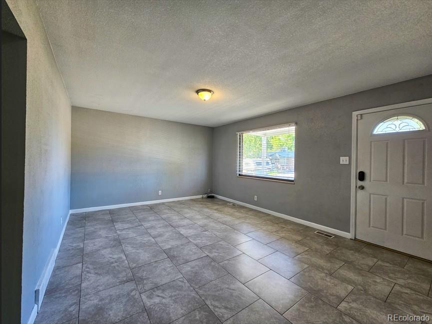 5542 Scranton Street Denver, CO 80239 - Photo 25 of 36 a view of an empty room and window