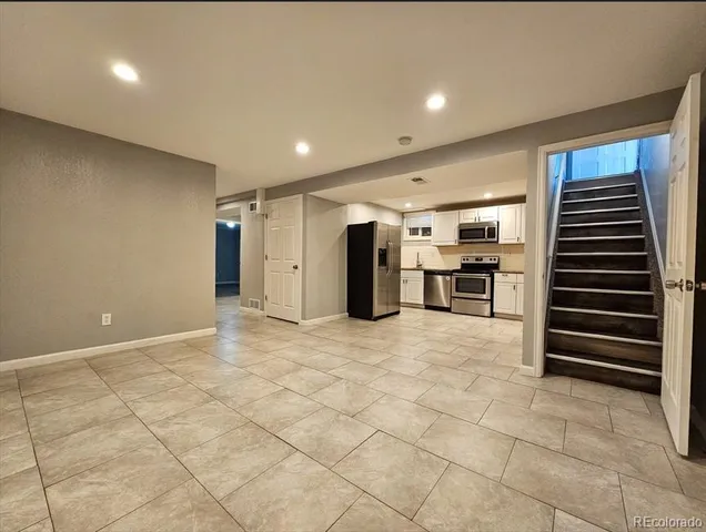 a view of kitchen with furniture and refrigerator