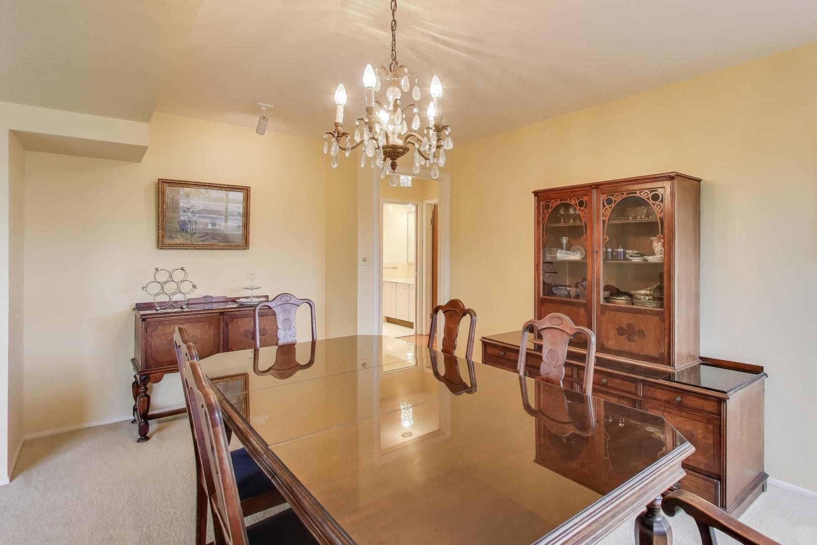 828 Oakton Street, Unit 5F Evanston, IL 60202 - Photo 15 of 37 a dining room with furniture and chandelier