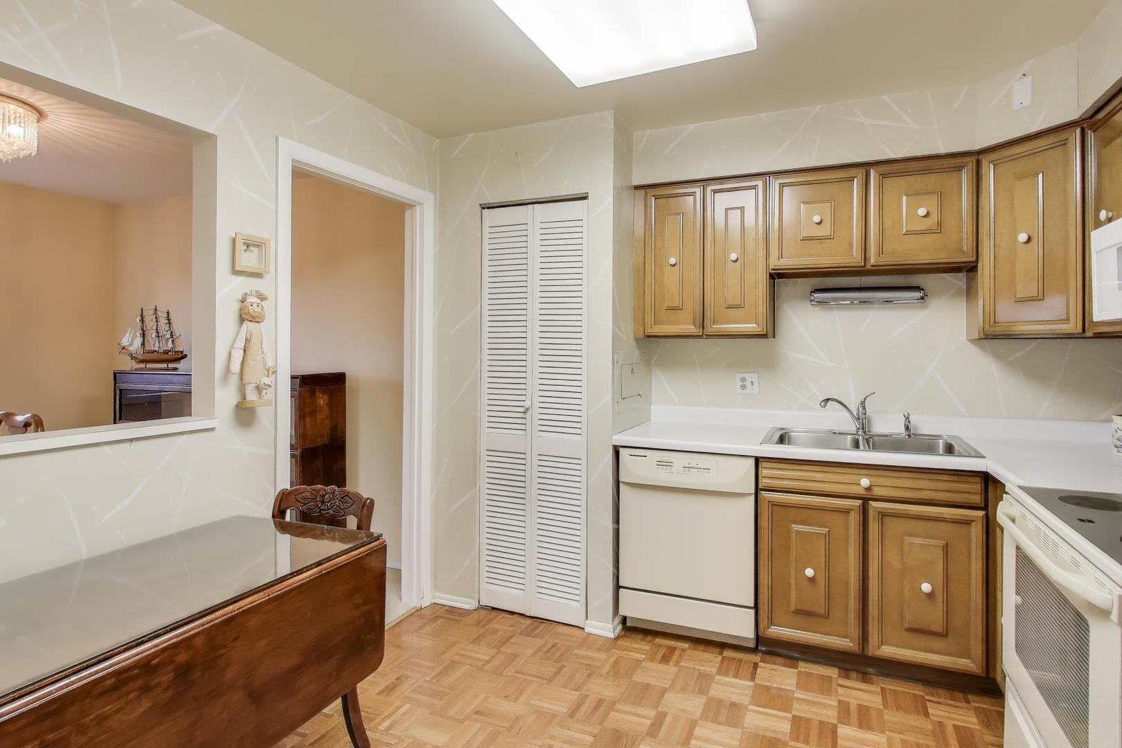 828 Oakton Street, Unit 5F Evanston, IL 60202 - Photo 17 of 37 a kitchen with a sink stove and cabinets