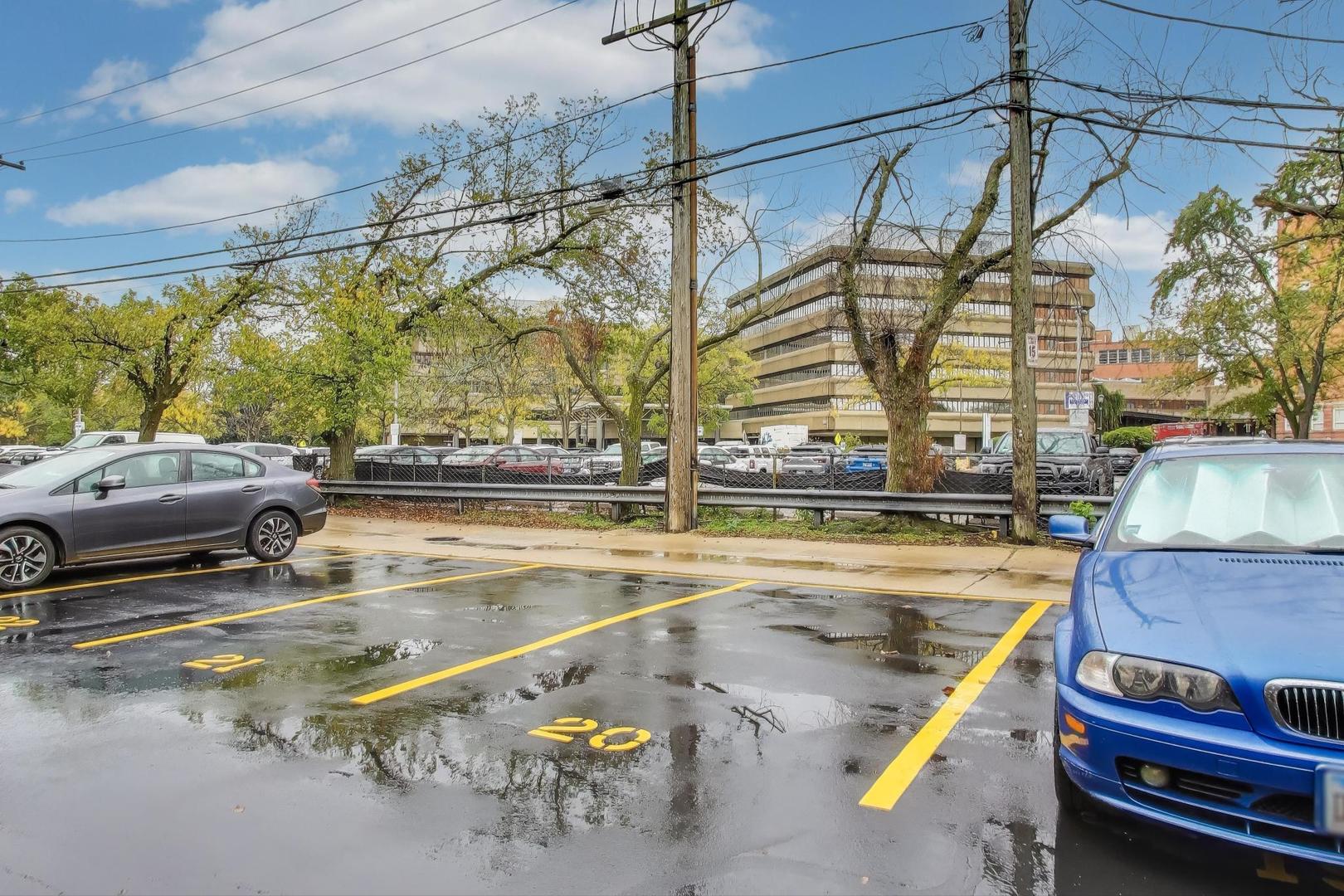 828 Oakton Street, Unit 5F Evanston, IL 60202 - Photo 36 of 37 a view of a swimming pool with a lawn chairs under an umbrella