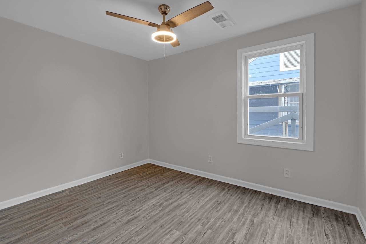 4251 Riviera Drive Memphis, TN 38108 - Photo 13 of 16 wooden floor in an empty room with a window