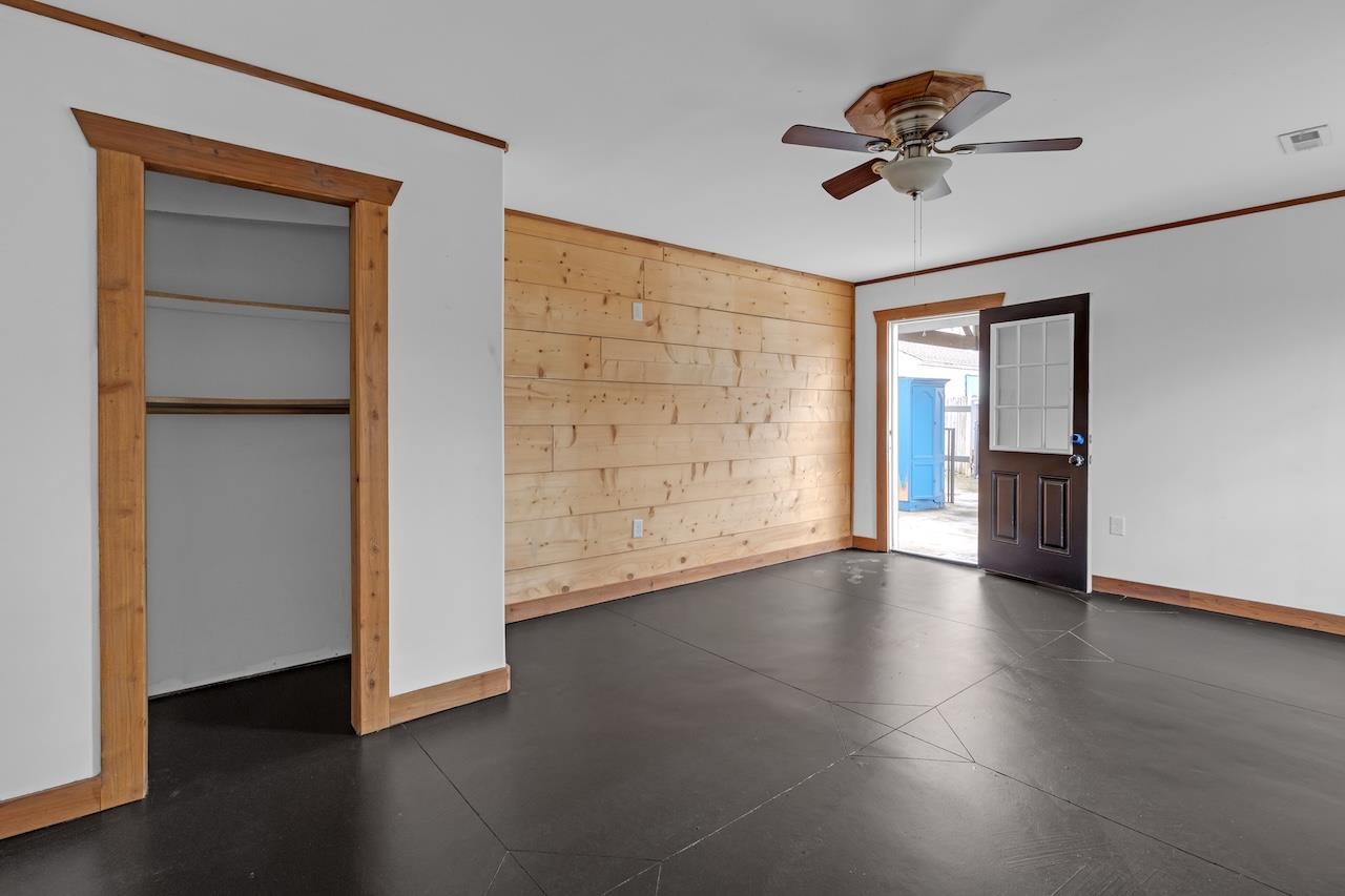 4251 Riviera Drive Memphis, TN 38108 - Photo 15 of 16 an empty room with wooden floor cabinet and windows
