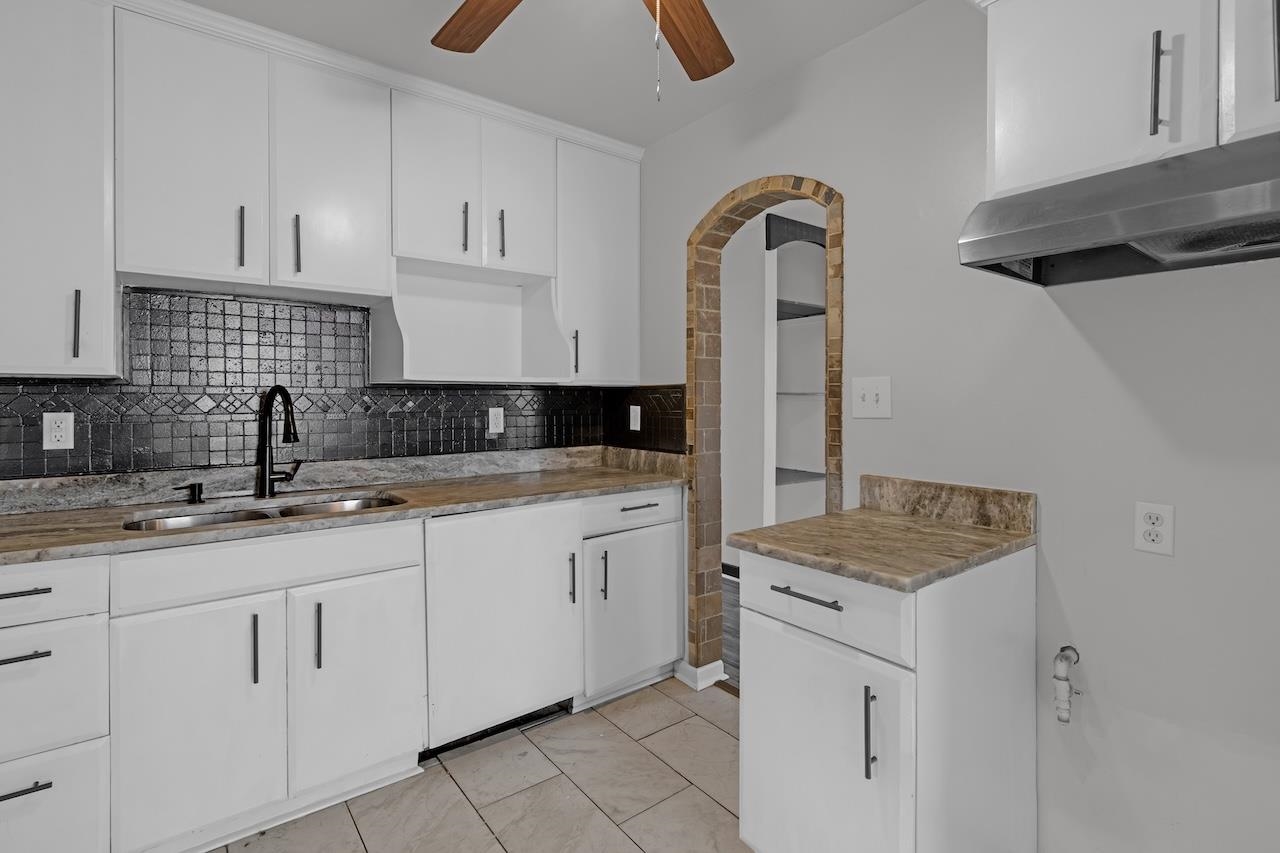 4251 Riviera Drive Memphis, TN 38108 - Photo 7 of 16 a kitchen with granite countertop white cabinets and sink