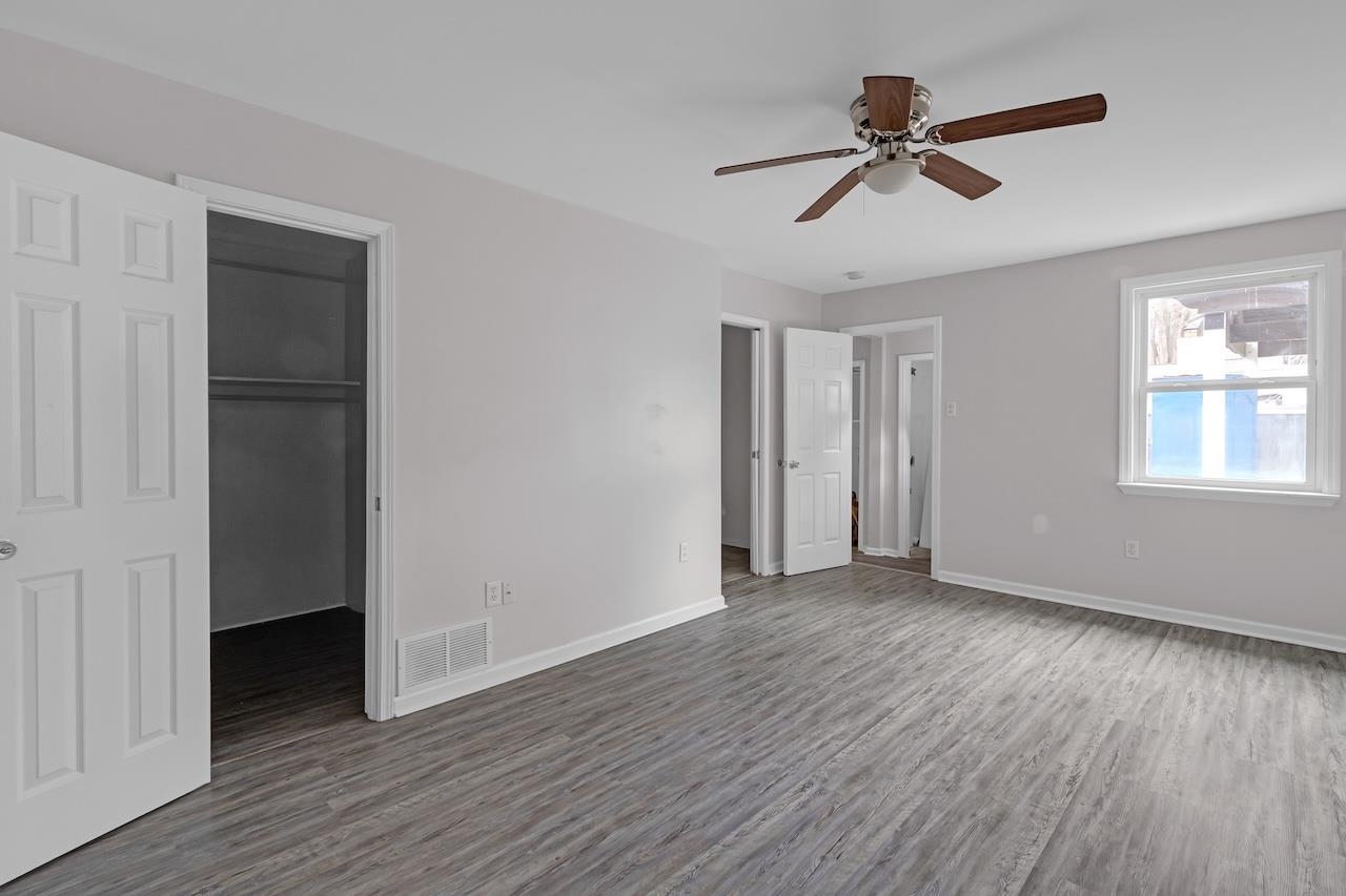 4251 Riviera Drive Memphis, TN 38108 - Photo 10 of 16 a view of empty room with wooden floor and ceiling fan