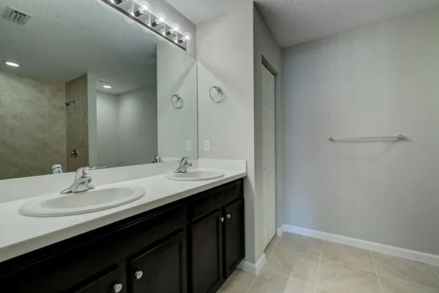 a bathroom with a double vanity sink a and mirror