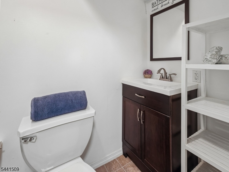 610 River Road Chatham, NJ 07928 - Photo 29 of 42 a bathroom with a toilet a sink a vanity and mirror