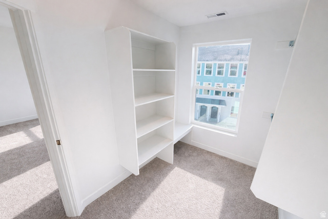 11014 South Lake Run Road, Unit 146 South Jordan, UT 84009 - Photo 11 of 22 White built-in shelving unit with an integrated desk surface