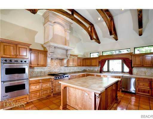 400 Cedar Ridge Drive Lake Arrowhead, CA 92352 - Photo 6 of 8 a kitchen with stainless steel appliances granite countertop a stove a sink and a microwave