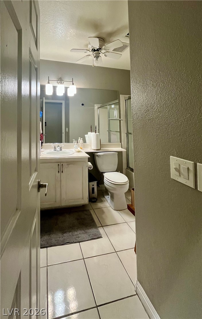 15 Rue Des Champs Henderson, NV 89074 - Photo 14 of 23 Tiled flooring and a crisp white vanity complete this functional bathroom space.