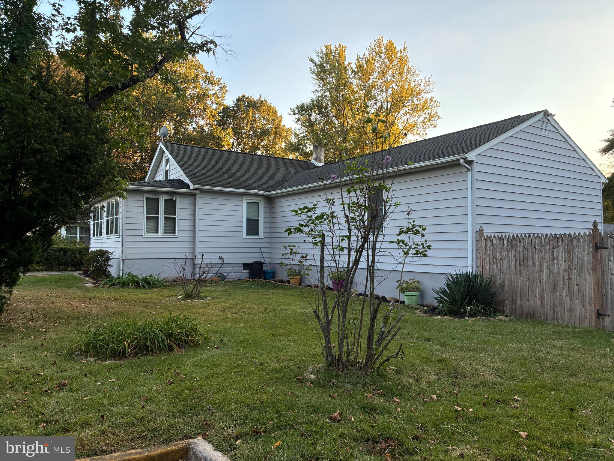 9 Frazier Street Burlington, NJ 08016 - Photo 3 of 33 a backyard of a house with potted plants and large tree