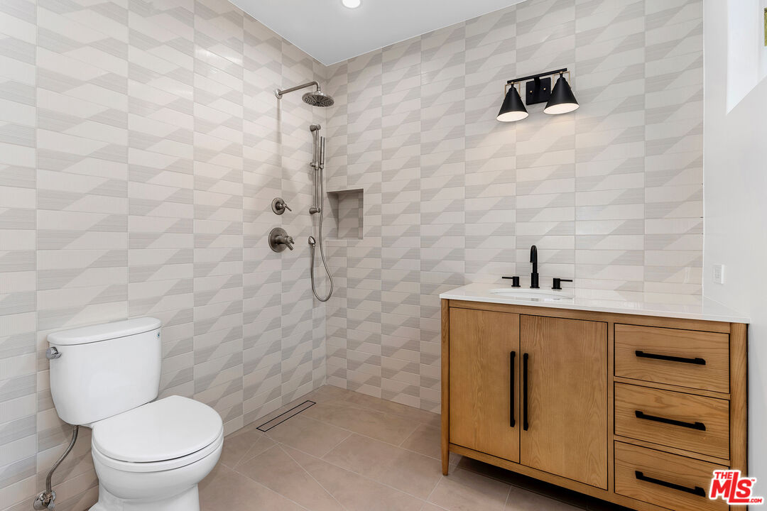 1901 South Point View Street Los Angeles, CA 90034 - Photo 18 of 21 a bathroom with a sink a toilet and a shower