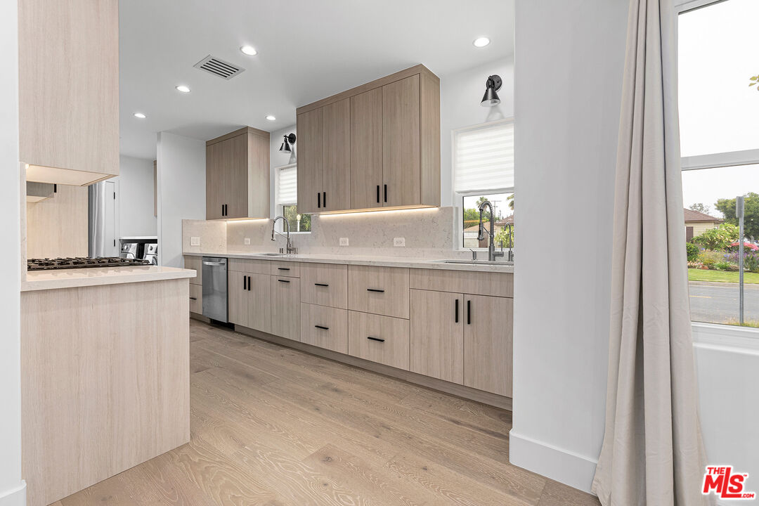 1901 South Point View Street Los Angeles, CA 90034 - Photo 7 of 21 a large kitchen with a lot of counter space and wooden floor