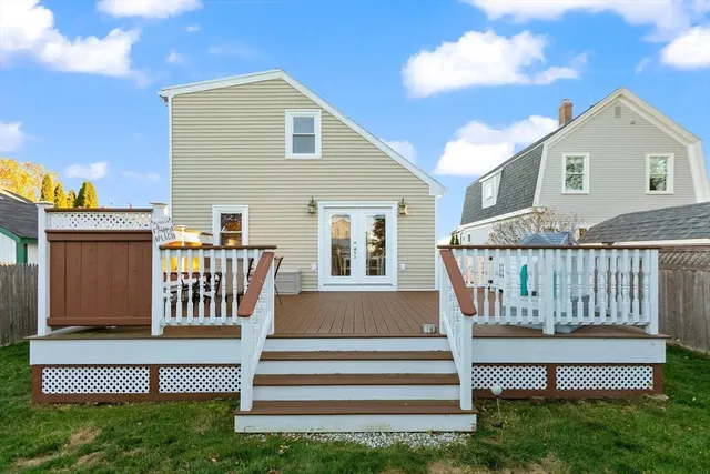 a view of a house with a deck and a floor to ceiling window