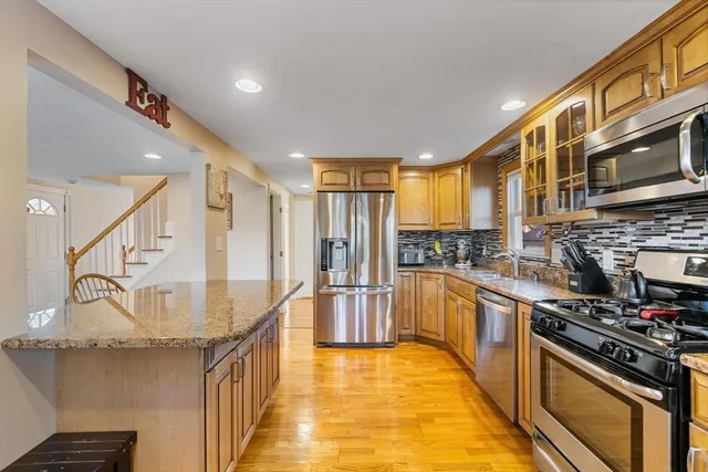a kitchen with stainless steel appliances granite countertop a stove and a refrigerator