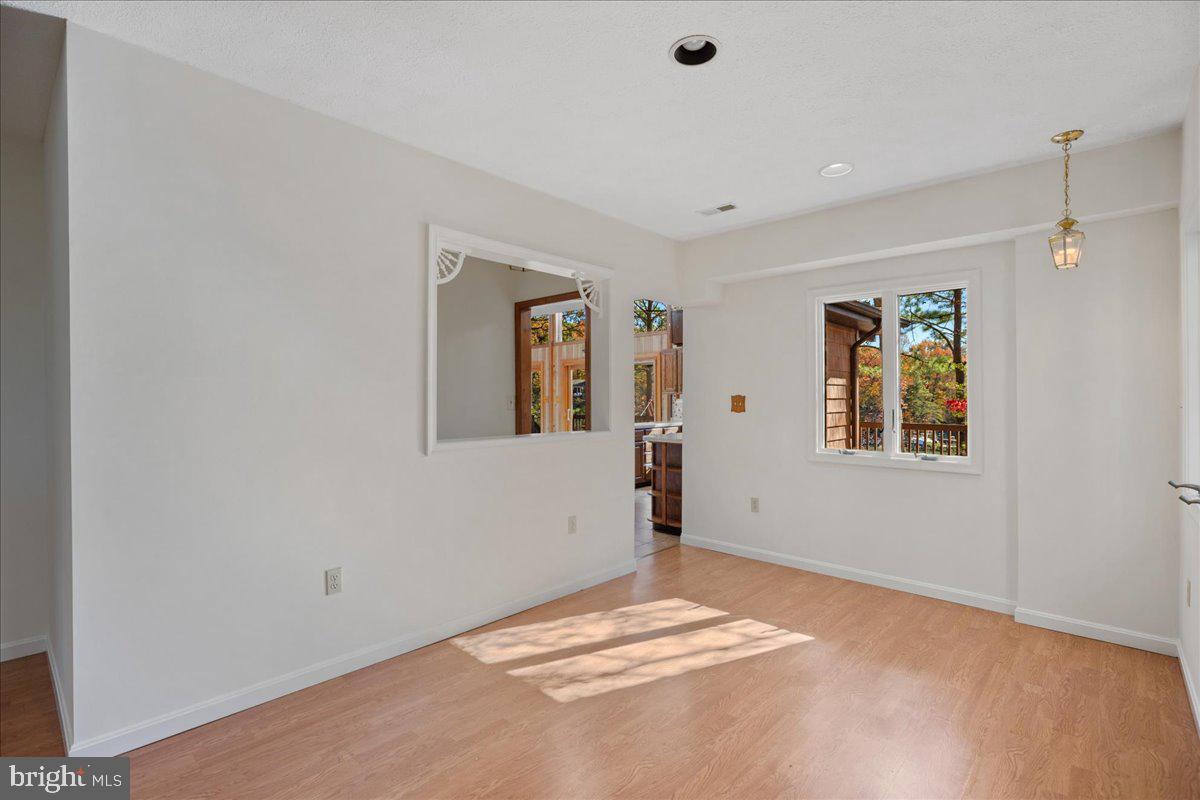 13140 Soundings Road Lusby, MD 20657 - Photo 12 of 81 a view of a livingroom with wooden floor and windows