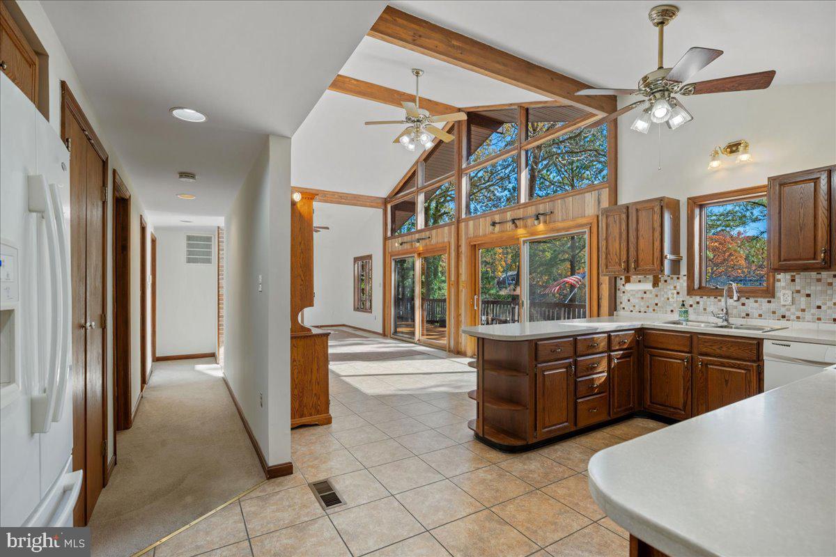 13140 Soundings Road Lusby, MD 20657 - Photo 18 of 81 a large kitchen with kitchen island granite countertop a large window and stainless steel appliances
