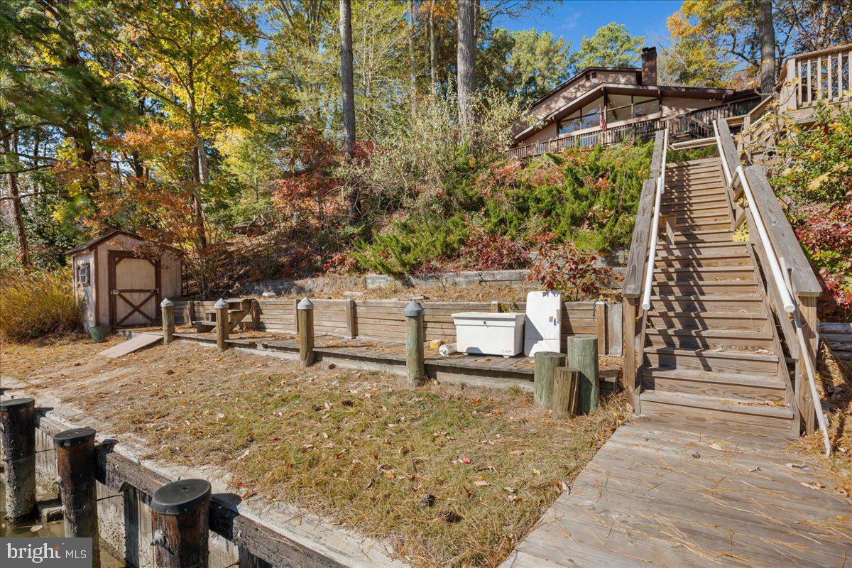 13140 Soundings Road Lusby, MD 20657 - Photo 33 of 81 Large landing area at pier w/ 2 sheds on the water