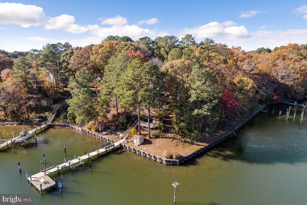 13140 Soundings Road Lusby, MD 20657 - Photo 4 of 81 a view of a lake with lawn chairs