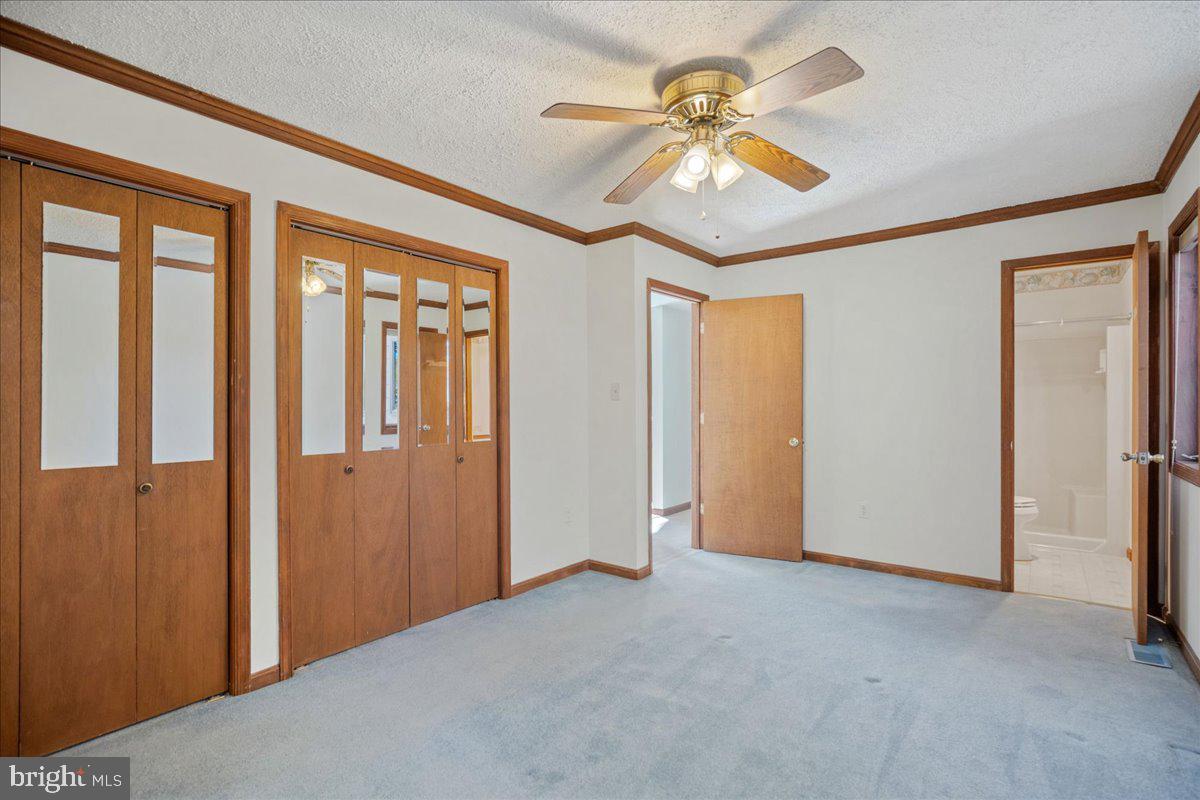 13140 Soundings Road Lusby, MD 20657 - Photo 45 of 81 a view of a livingroom with a ceiling fan and a chandelier fan