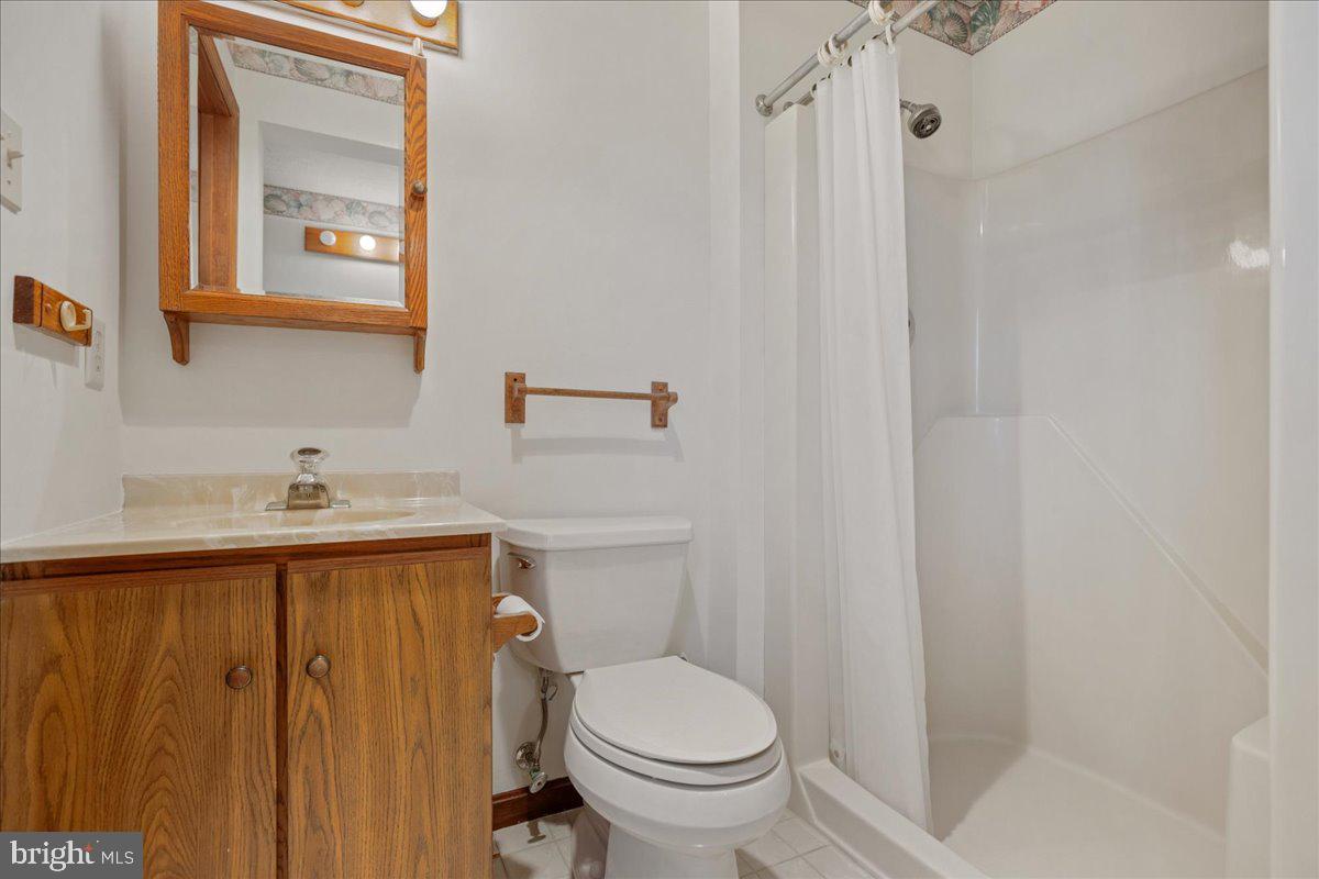 13140 Soundings Road Lusby, MD 20657 - Photo 47 of 81 a bathroom with a sink a toilet and shower