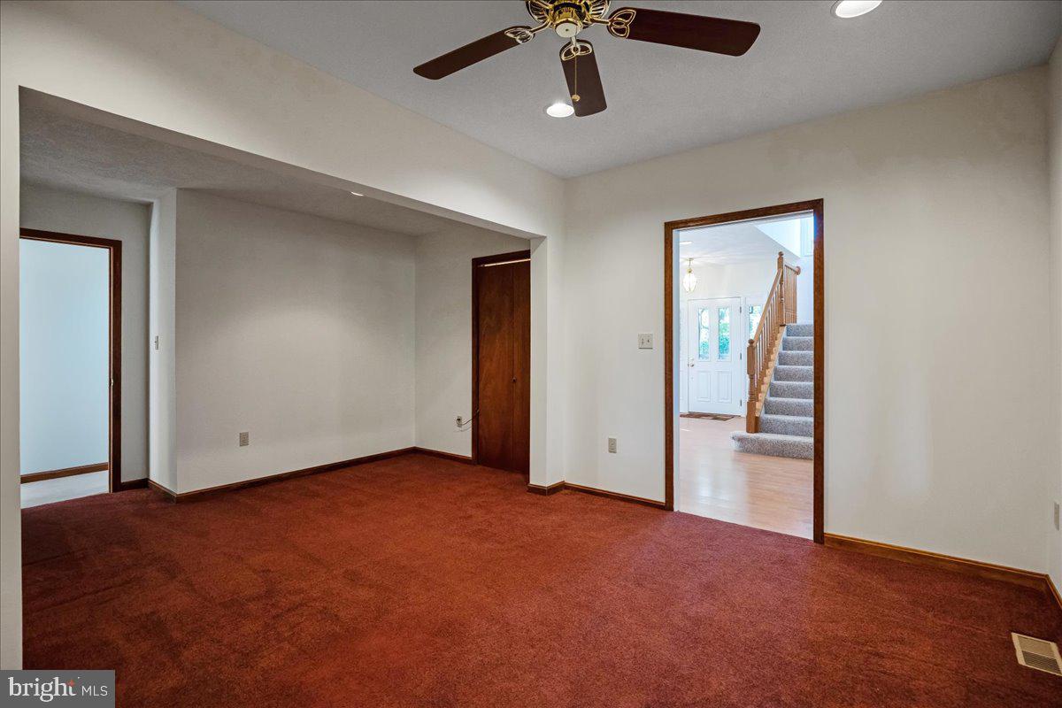 13140 Soundings Road Lusby, MD 20657 - Photo 49 of 81 an empty room with closet and a chandelier fan