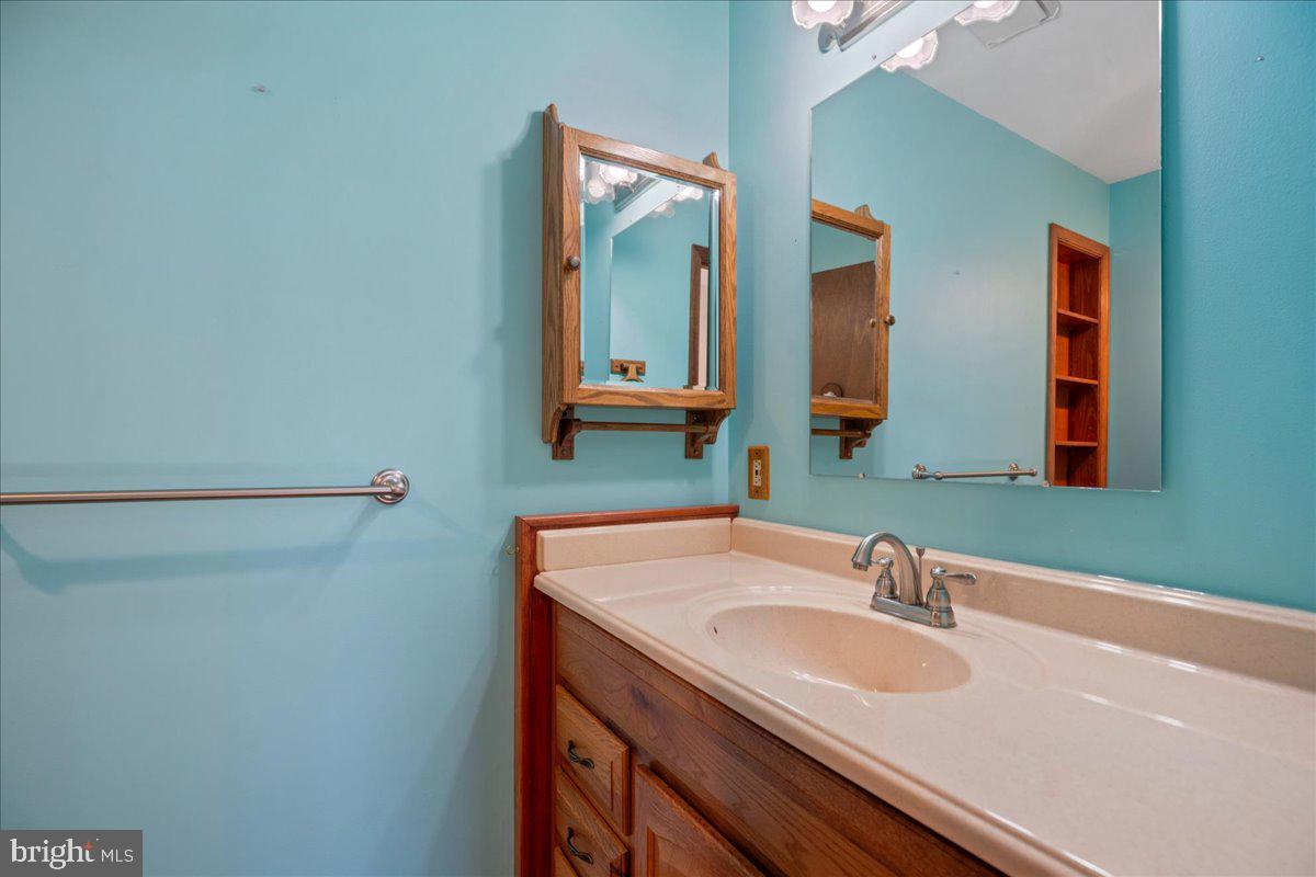 13140 Soundings Road Lusby, MD 20657 - Photo 50 of 81 a bathroom with a sink and a mirror
