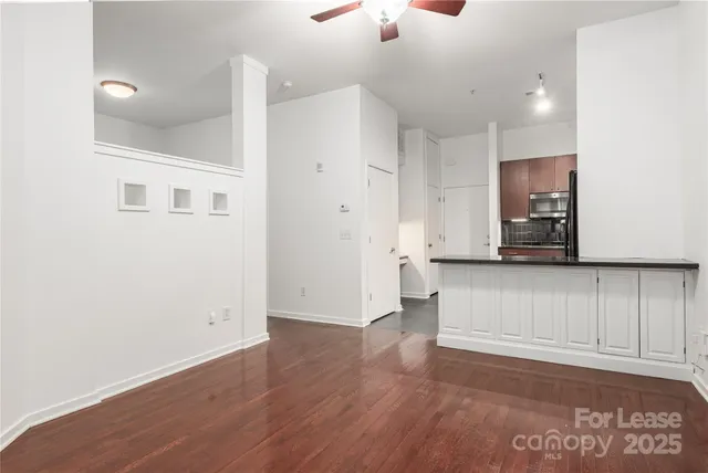 a view of a kitchen with wooden floor