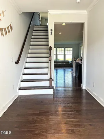 a view of entryway and hall with wooden floor