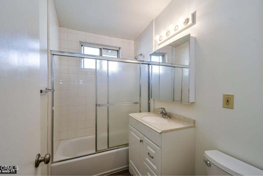 2707 Montrose Avenue, Unit 10 Montrose, CA 91020 - Photo 11 of 15 a bathroom with a shower sink and mirror