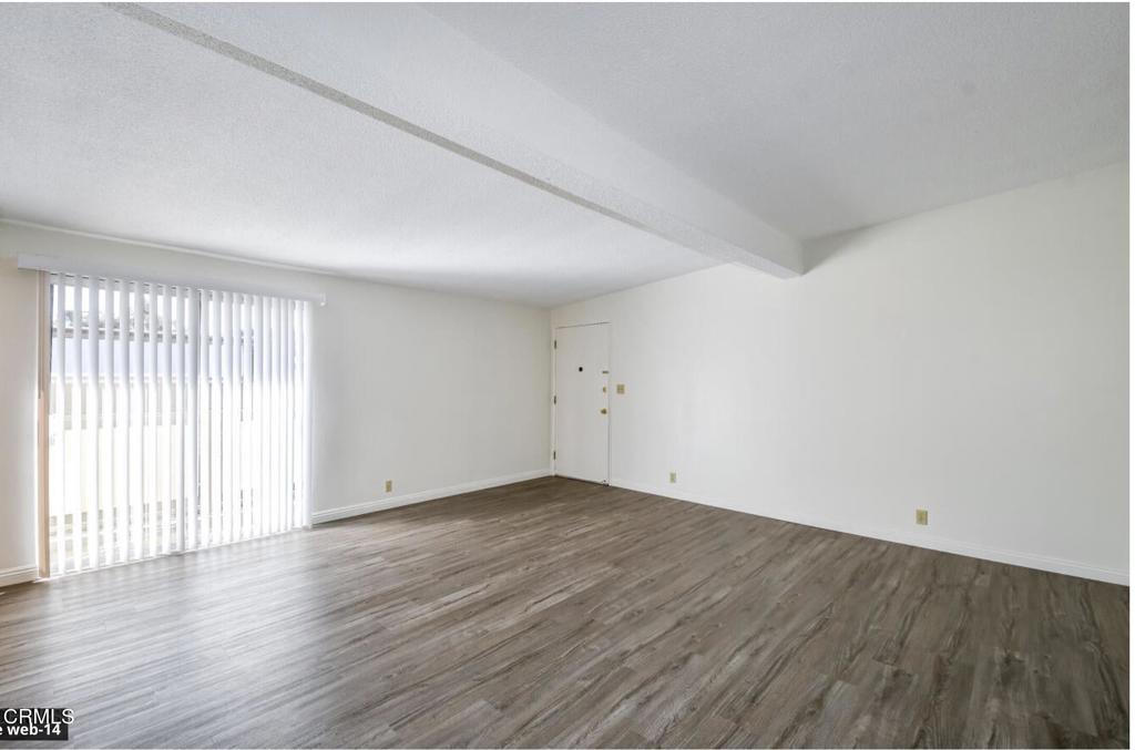 2707 Montrose Avenue, Unit 10 Montrose, CA 91020 - Photo 4 of 15 an empty room with wooden floor and windows