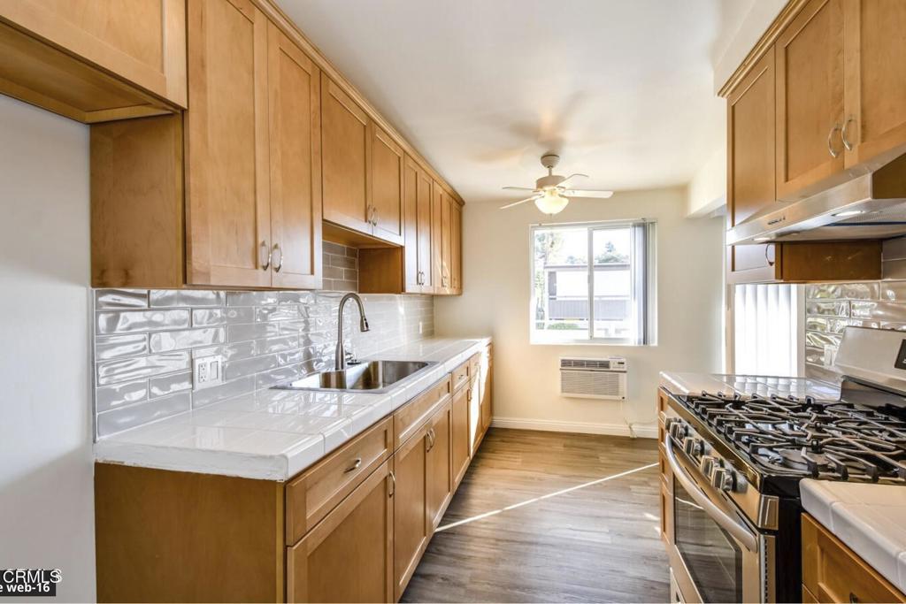 2707 Montrose Avenue, Unit 10 Montrose, CA 91020 - Photo 7 of 15 a kitchen with stainless steel appliances a sink stove and cabinets