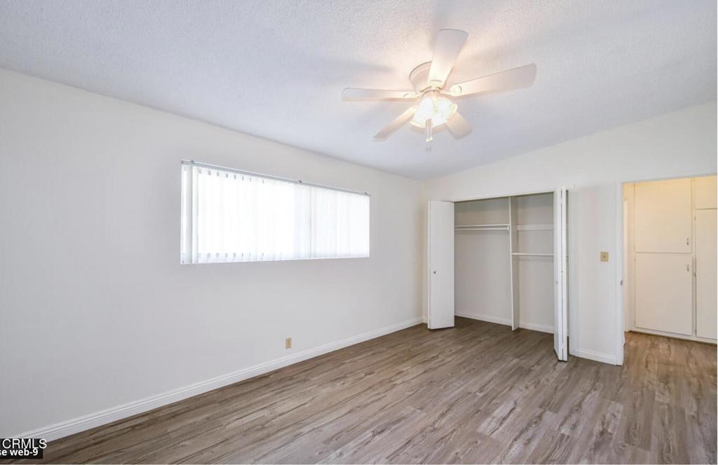 2707 Montrose Avenue, Unit 10 Montrose, CA 91020 - Photo 10 of 15 an empty room with wooden floor and windows