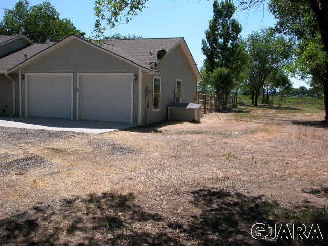 7715 Dover Road Delta, CO 81416 - Photo 23 of 33 a front view of a house with a yard