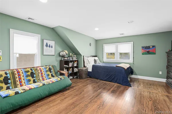 a bedroom with furniture and a large window