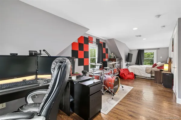 a living room with furniture a flat screen tv and a large window